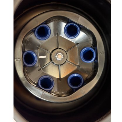 Top-down close-up view of the interior rotor assembly, featuring a metallic six-place fixed-angle rotor populated with six blue specimen tube holders.