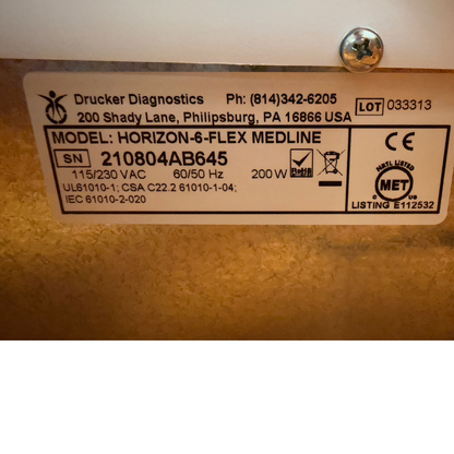 Close-up of the manufacturer specification label for the centrifuge, displaying the Drucker Diagnostics brand, model HORIZON-6-FLEX MEDLINE, serial number 210804AB645, lot 033313, and power requirements