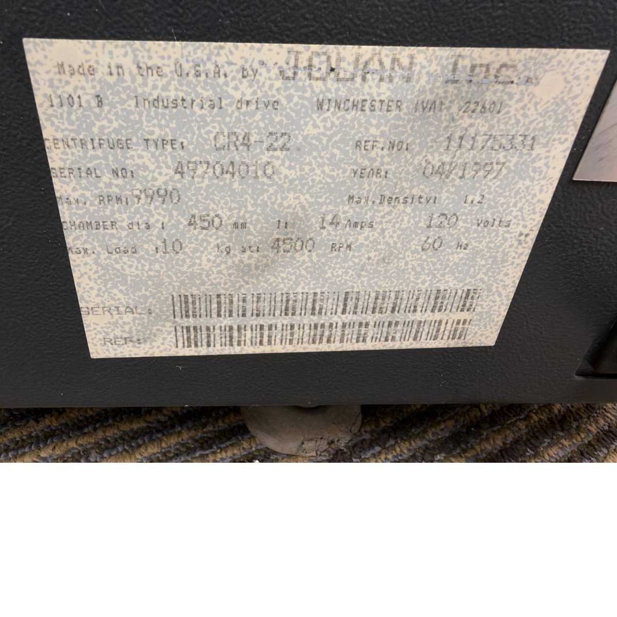Close-up of the manufacturer serial specification label for Jouan Inc CR4-22 showing model details, 120V power specs, and 9990 max RPM.