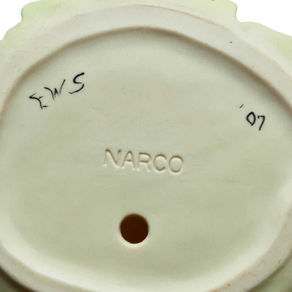 Bottom view showing artist signature on porcelain figurine base