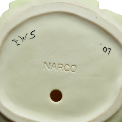 Bottom view showing artist signature on porcelain figurine base