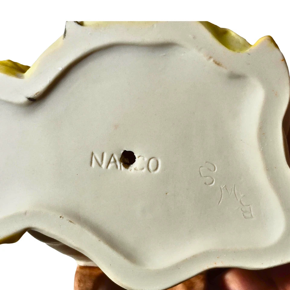Bottom view showing artist signature on porcelain figurine base