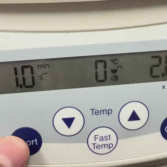 Video showing a close-up of the Eppendorf 5415 R digital control panel in operation. A finger presses and holds the "Short" spin button, while the LCD screen displays the timer counting up in seconds, a temperature reading of 2°C, and the speed accelerating to 2,800 RPM before decelerating when the button is released.