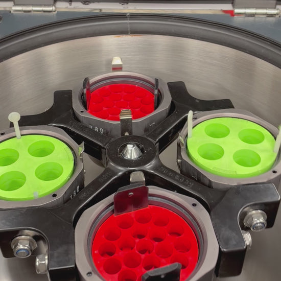 Demonstration video of a Jouan CR4-22 refrigerated centrifuge. A gloved hand rotates the internal 4-place swing bucket rotor to inspect it, closes the heavy lid, presses the start button on the front control panel, and the digital display shows the rotation speed ramping smoothly up to 1500 RPM before being manually stopped.   