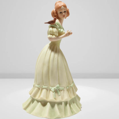 Victorian porcelain figurine of young lady with bird