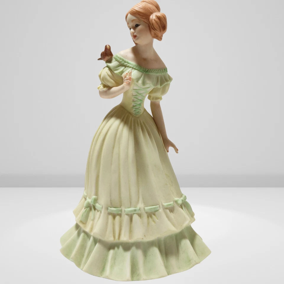 Victorian porcelain figurine of young lady with bird