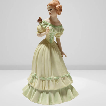 Victorian porcelain figurine of young lady with bird
