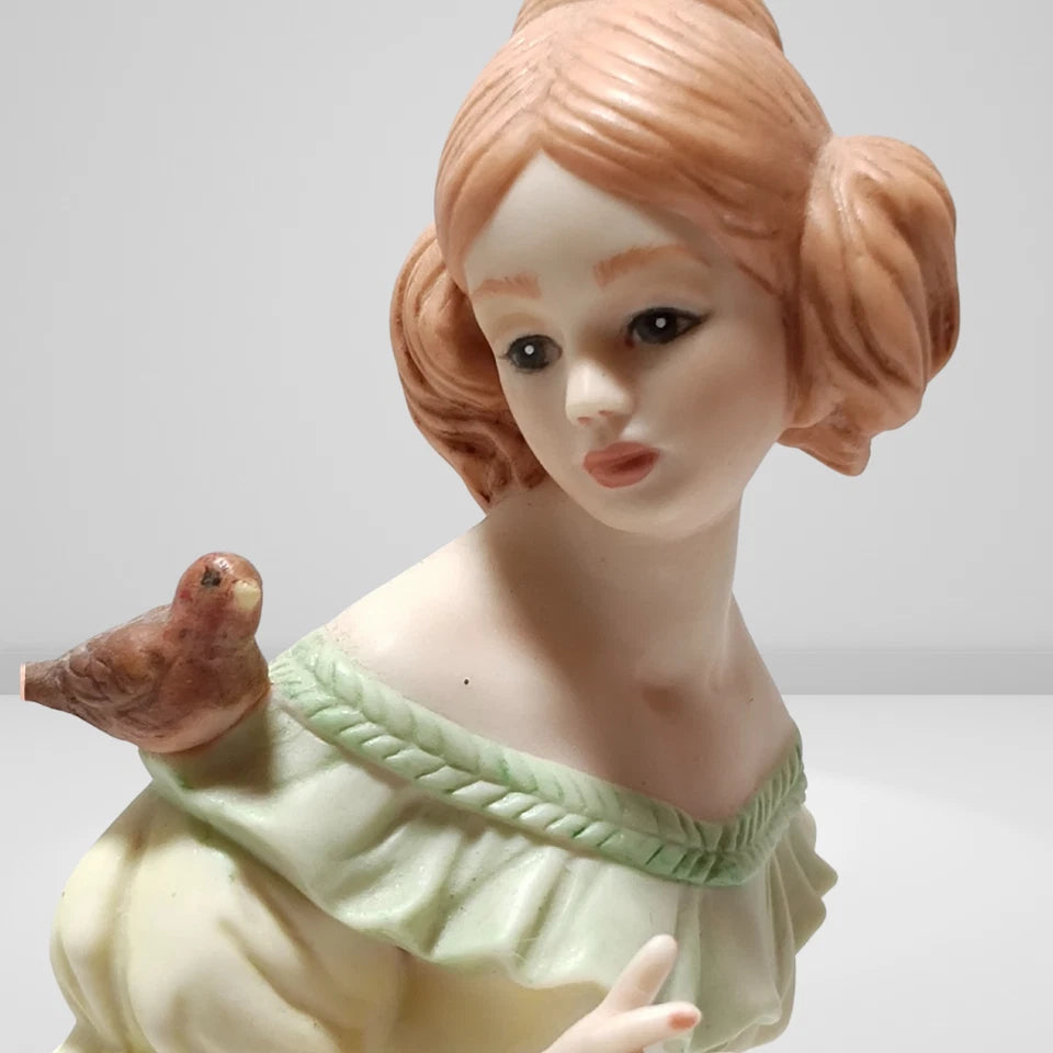 Close-up of hand-painted Victorian porcelain figurine face with bird